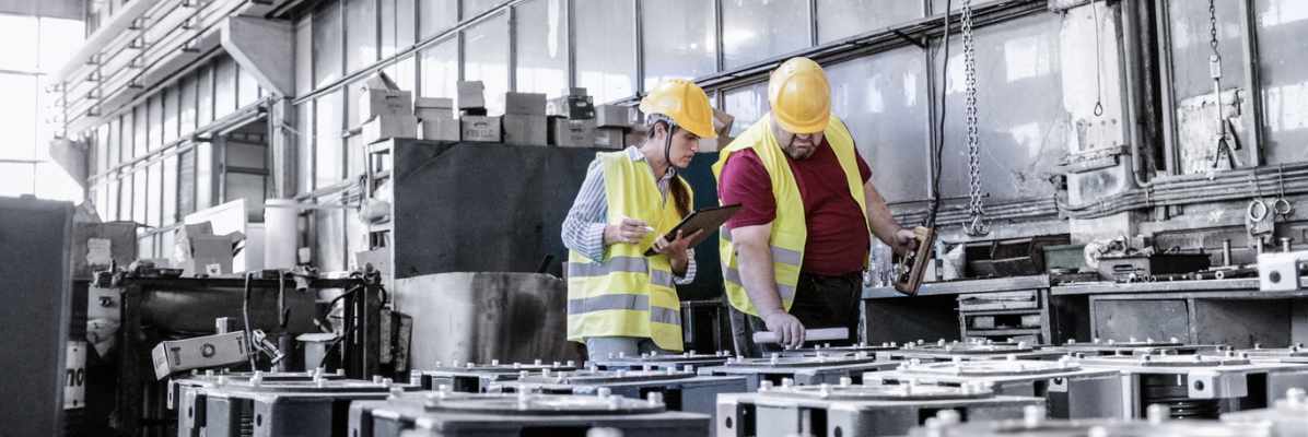 Engineers working in metal manufacturing industry with tablet.